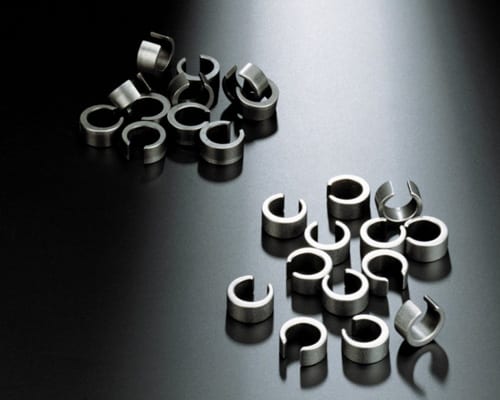 Stamped spring clips used to compare surface condition during a mass finishing trial